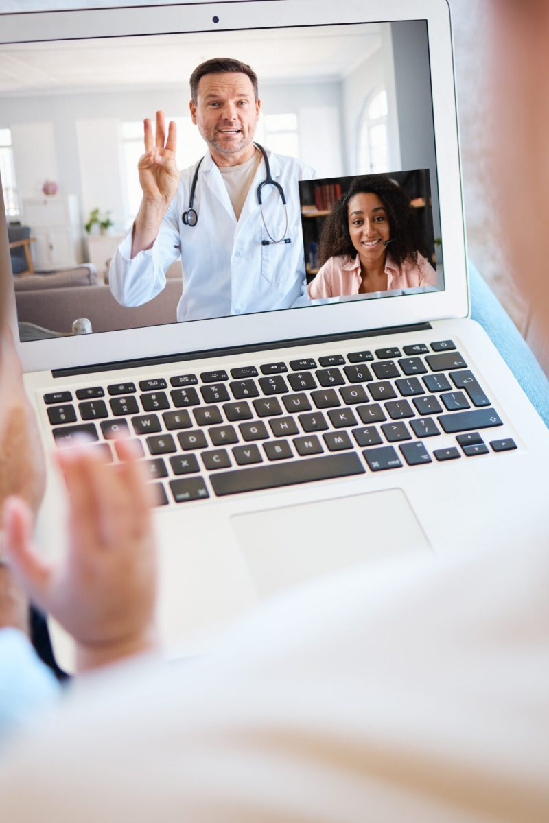 Shot of a unrecognizable boy and his father using a laptop for a video call at home.